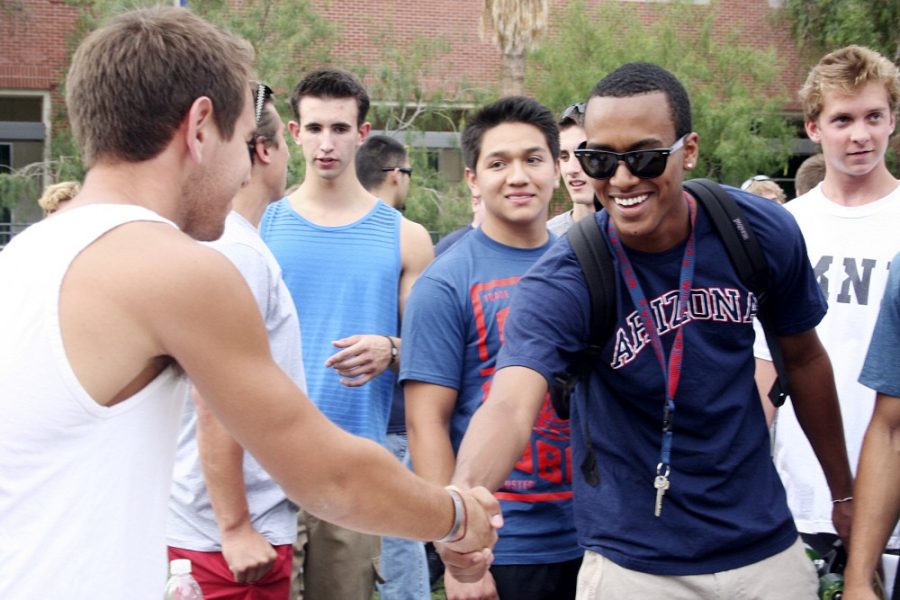 Michelle A. Monroe / Arizona Daily WIldcat

David Dixon, left, a pre-business sophomore and Sigma Alpha Epsilon  member, greets Nate Muluneh, a pre-business freshman, at a pre-rush information session on the UA Mall on Thursday Aug. 25. . Interfraternity Council rush begins on Monday.