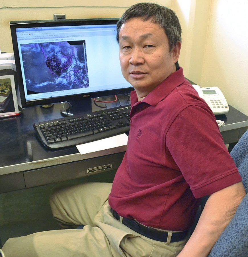Zachary Vito / Arizona Daily Wildcat
Xubin Zeng, professor of atmospheric sciences at the UA, studies local monsoon patterns in his office on Tuesday, Aug. 30. Zeng is conducting a $3 million study to help battle forest fires in Arizona.  
