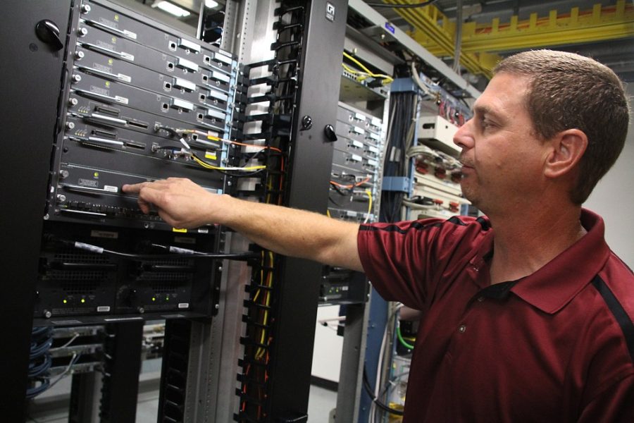 Kevin Brost / Arizona Daily Wildcat
Ken Boynton demonstrates how the routers and wireless service modules located in the Computer Sciences building help distribute wireless internet to nearly all of the University of Arizona on October 11, 2011.
