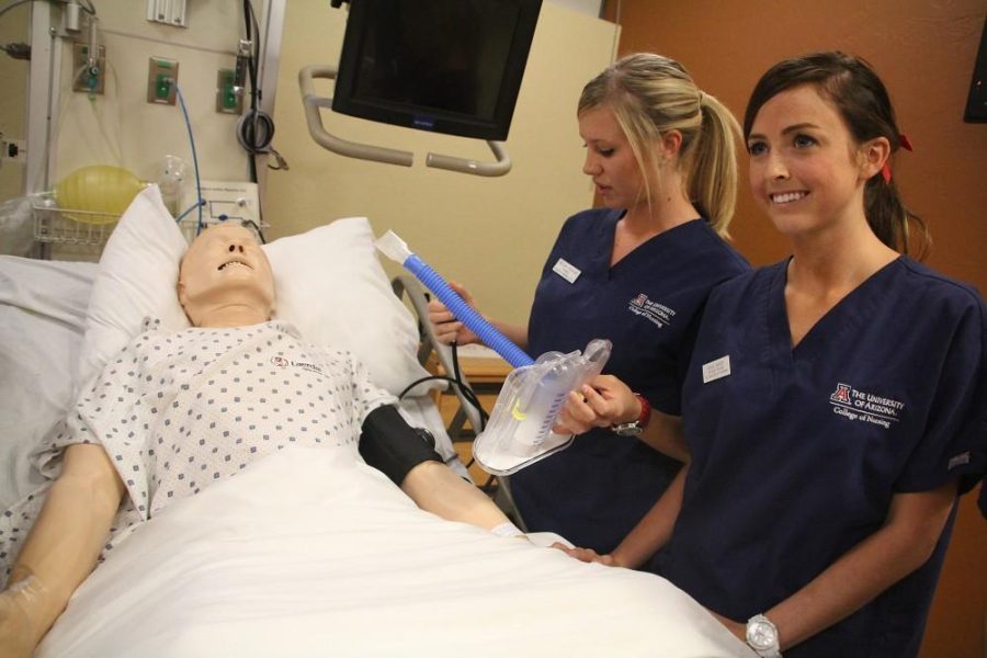 Kevin Brost / Arizona Daily Wildcat
Megan Graham and Devon Cassidy, college of nursing students, discuss the procedures and demonstrate the technology used in their nursing school practices at The College of Nursing on October 11, 2011.