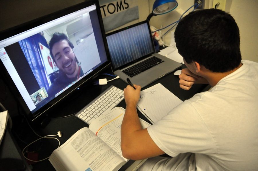 Freshman undergraduates Brandon Mahoney (left) and Brian Levine (right) work on their math homework via Skype.  The students use Skype to do math homework from the comfort of their dorm rooms.