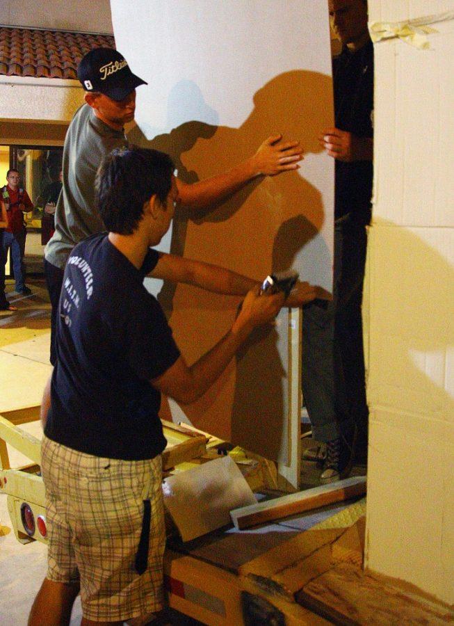 Gordon Bates/ Daily Wildcat
Members of Theta Tau create their homecoming float. All of the wood was donated from Grant Rd. Lumber.