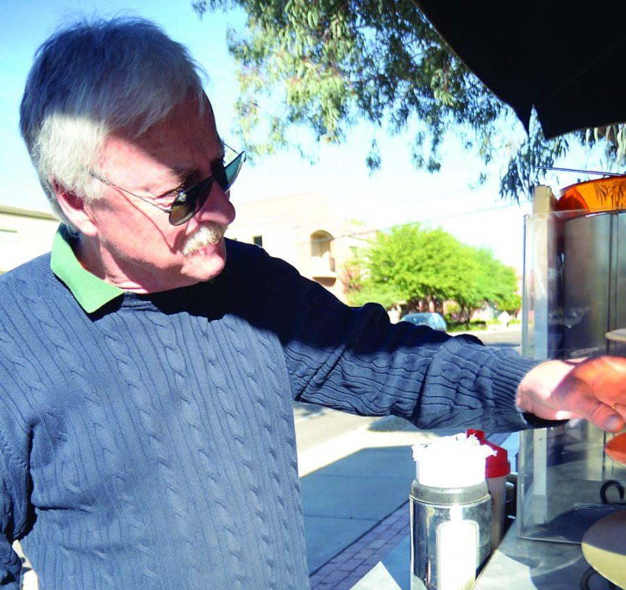 Colin Prenger / Arizona Daily Wildcat

Dan Mathy, owner of Mojo coffee stand near the Newman Building, makes coffee and serves students breakfast food each morning.
