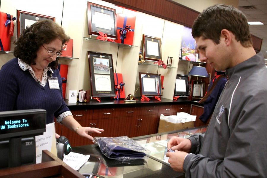 Kevin Brost / Arizona Daily Wildcat
Harry Siskin purchases a cap and gown for winter graduation at the UofA Bookstore on Thursday Dec. 1. 