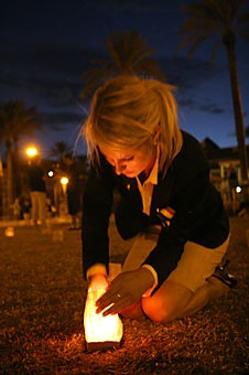 Associated Students of the University of Arizona President Erin Hertzog lights a luminaria during last nights freedom walk in remembrance of the victims of the terror attacks on Sept. 11, 2001. Students walked around the UA Mall, which was bordered by luminarias symbolizing each of the targets.
