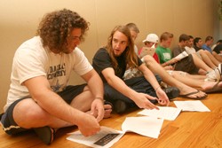 Josh Levy, 18, an undeclared freshman and Dan Shtutman, 18, a physiology freshman, look over a packet of information and a survey at the Fraternity Rush in the SUMC North Ballroom Monday afternoon. 