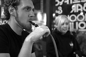 Pre-business freshman Sean Moran and pre-physiology freshman Roxanna Hobbi smoked hookah late last night at Espresso Art, 944 E. University Blvd. Smoking hookah may soon be banned on campus because of concerns about drug use and smoking in dorms.