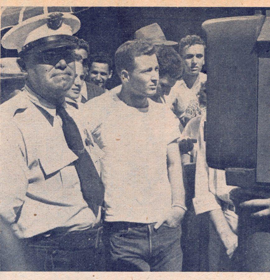 Merrill Windsor, president of the student body, in the custody of a Tucson policeman immedietly following the arrest that broke up the traditional pre-game rally. Windsor was accompanied to the City Hall by Vin Ciruzzi, chairman of the traditions committee. 