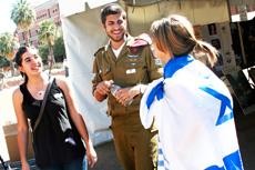 From left, Keisey Kendelman, sophomore, Gil Wasserman, senior and Rachel Fox, sophomore attend the Israel Week event out on the UA Mall Wednesday. Wasserman wears an Israel Defense Force uniform and in August he will be enlisting in the Israeli military service.