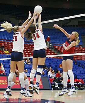 Arizona middle blocker Stephanie Snow (55) and setter Paige Weber (34) work together to block Jacy Nortons attempt to score. With many players lost to injuries, the three underclassmen and the rest of the volleyball team will make do with what they have today and tomorrow at the Sheraton Four Points Wildcat Classic in McKale Center.  