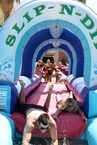 Lisa Beth Earle/ Arizona Daily Wildcat

Ross Shanken, a marketing sophomore, and Kerry Beckett, a media arts sophomore, give the Slip N Dip their best slide on the UA mall on Thursday, April 15. The inflatable water slide was part of the 1st annual swimsuit day, hosted by Remix-Nation.