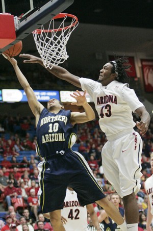 UA forward Jordan Hill rejects NAU guard Cameron Jones during a 74-57 Wildcat win in McKale Center on Sunday afternoon. Hill scored a game-high 23 points to go with his 10 rebounds, marking his fourth double-double of the season.