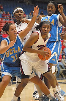 UA guard Joy Hollingsworth looks for a shot inside while being defended by a pair of Bruins during Arizonas 76-73 loss to UCLA Saturday in McKale Center. Hollingsworth had 23 points, seven rebounds, seven assists, five 3-pointers and three steals in 37 minutes, all of which tied team highs or better.