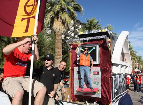 Ernie Somoza / Arizona Daily Wildcat

Members of Theta Tau ride a top their float based on the sci-fi film Back to the Future. Theta Tau takes the win for 12 consecutive year in the 2010 homecoming parade float competition.