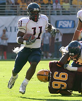 Former Arizona running back Mike Bell looks for a hole as he carries the ball in his last game as a Wildcat against ASU on Nov. 25 at Sun Devil Stadium. Bell rushed for 952 yards in his senior season. 