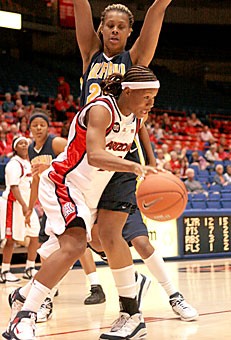 Arizona senior guard Natalie Jones drives past California defender Devanei Hampton. Jones dropped 12 points on the Bears as the Wildcats dropped their seventh straight game, losing to Cal last night 73-56 in McKale Center.
