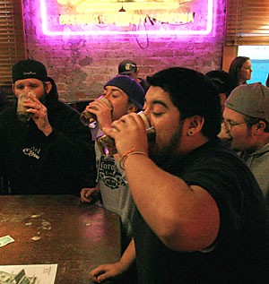 No Anchovies employees Steve Romo front, Steven Massani, Steven Elsworth, Bobbi Duffik and Jason Greenway compete in an Irish car-bomb drinking game at the pizzeria yesterday afternoon. The Arizona Legislature is considering a bill that would ban the power hour.