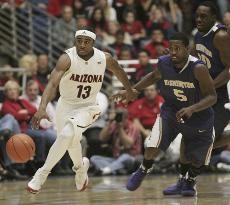 Washington guard Justin Dentmon (5) tries to run down Arizona point guard Nic Wise in a 106-97 Wildcat win on Thursday in McKale Center. The UAs wins over the Washington schools were fueled by sudden scoring surges midway through the second half.