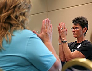 Joan Schlimgen, a yoga and pilates instructor at the UMC Health and Wellness Center, gives a chair yoga class yesterday morning at the Well University Day in the SUMC.