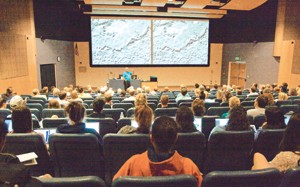 Peter Smith, principal investigator of the UA Mission to Mars, shows audience members photographs of Mars' red exterior surface at the first public Mars discussion of the semester Tuesday night.