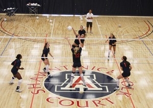 Sophomore middle blocker Stephanie Snow hits the ball in practice on Wednesday in the new basketball and volleyball practice facility east of McKale Center. The court is named in honor of Shawntinice Polk, a UA womens basketball player who died of a blood clot in September 2005.