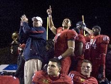 Arizona head coach Mike Stoops, far left, and other Wildcats celebrate their first bowl game win since 1998 after a 31-21 win over No. 17 BYU in the Pioneer Las Vegas Bowl at Sam Boyd Stadium on Saturday night.