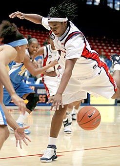 Sophomore guard Ashley Whisonant loses the ball in traffic during Arizonas 90-64 loss to UCLA Saturday in McKale Center. Whisonant was one of five Wildcats to play more than 30 minutes, as the team had only six scholarship players available for most of the game because of injuries. 