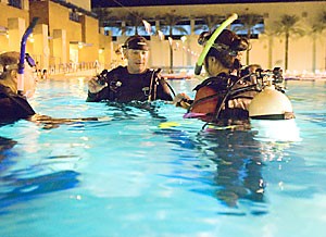 Scuba diving instructor Eric Fairfield (center), teaches Tracy Min (right), and Alan Nyitray how to scuba dive in the Student Recreation Center pool on Sept. 17.  A group of students have been training for a trip to Mexico on Friday during which they will dive in the Sea of Cortez.