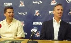 UA mens basketball assistant coach Russ Pennell, left, and associate head coach Mike Dunlap address the media in McKale Center on Monday. The coaches are hoping to instill a new system of trust in the program.