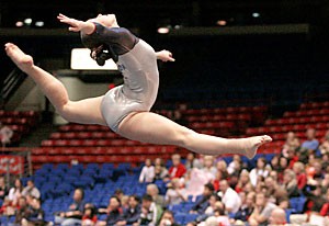 Arizona Gymcats junior Jamie Holton leaps in the air during her floor routine at the Wildcats win over California Feb. 3. The Wildcats hope to extend their win streak to three meets when they travel to Corvallis, Ore. to take on the Oregon State Beavers tonight.
