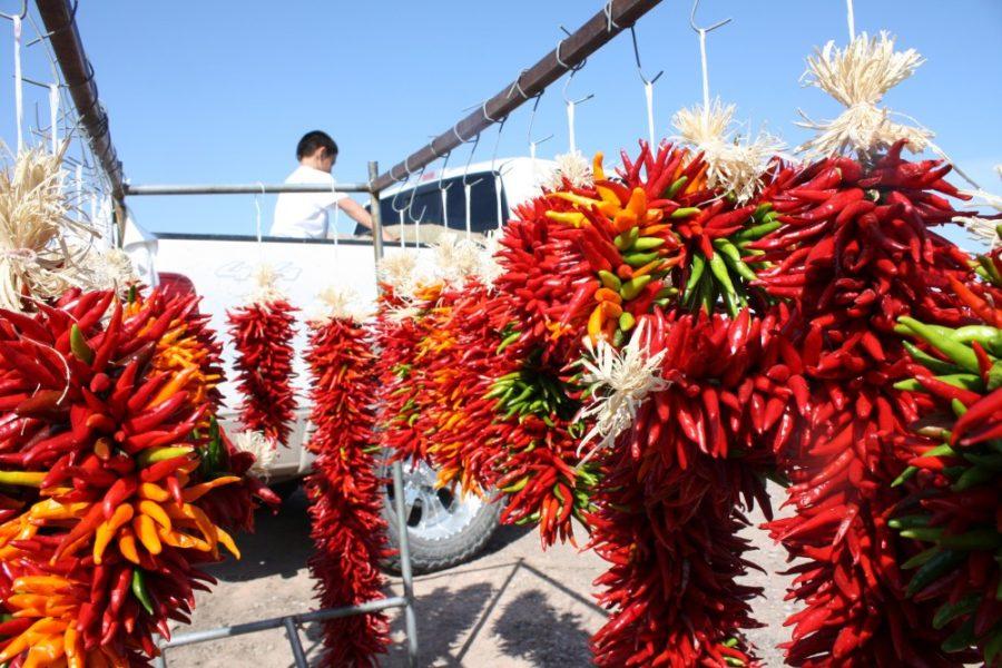 Tim McDonnell / Arizona Daily Wildcat  A vendor unloads chiles from a truck behind a display of chile wreaths, known as ristras at the Hatch Chile Festival in Hatch, New Mexico on Saturday, Sept. 5. 