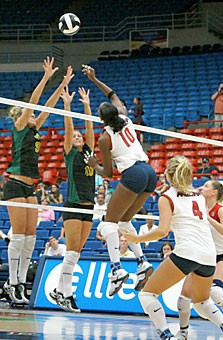 UA junior middle blocker Dominique Lamb hits the ball over the net in the Wildcats 3-1 win over San Francisco Saturday in McKale Center. Lamb was named to the All-Tournament team after averaging 2.2 kills, 1.6 blocks and 0.5 digs, as the No. 18 Wildcats went 3-0 in the Arizona Invitational.