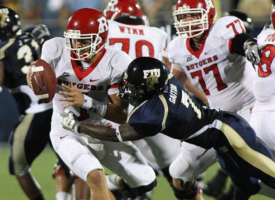 Rutgers quarterback Tom Savage, left, escapes the grasp of Florida Internationals Anthony Gaitor in the first quarter at FIU Stadium in Miami, Florida, on Saturday, September 11, 2010. 