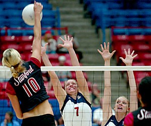 Stanford senior Kristin Richards, left, goes up for a kill as UA senior setter Stephanie Butkus and freshman middle blocker Jacy Norton attempt to block in Arizonas three-set loss to the Cardinal in McKale Center. The Wildcats didnt have much success blocking as Stanford swept the Wildcats for the second time this season.