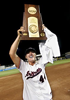 Arizona pitcher Alicia Hollowell raises the trophy over her head after Arizona defeated Northwestern for the NCAA Division I softball championship in Oklahoma City, yesterday.