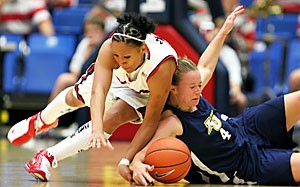 Arizona sophomore guard Marie McGee fights for the ball with Vanguards Sarah Boyd in the Wildcats 76-70 exhibition win Monday in McKale Center. The team opens up its regular-season schedule today in the WBCA/Basketball Travelers Classic in University Park, Pa. 