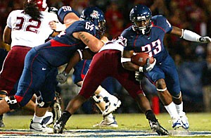 UA left guard Colin Baxter (64) creates a hole for tailback Nicolas Grigsby (23) during the Wildcats 48-20 rout of Washington State on Saturday at Arizona Stadium. Baxter was named a starter on the offensive line after Arizonas season-opening loss at Brigham Young. 