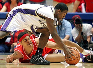 Claire C. Laurence/Arizona Daily Wildcat

Freshman forward Marcus Williams tries to regain control of the ball during a scuff with a Washinton defender. The Wildcats lost their final game of the season 70-67 on Saturday in McKale Center.