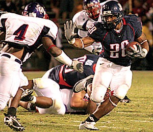 Running back Chris Jennings stiff arms a defender on his way to a 201-yard, two-touchdown game, Arizonas first 200-yard rusher since former back Mike Bell did it 2003, during the Wildcats 28-10 win over Stephen F. Austin Saturday at Arizona Stadium. The walk-on junior earned a scholarship from Arizona in the week leading up to the game.