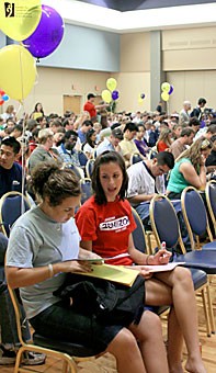 Public management and policy junior Meaghan Kramer, left, and physiology junior Jennifer Peterson, both members of the sophomore honorary Spires, share notes before the Club Recognition Assembly last night in the USMC North Ballroom.