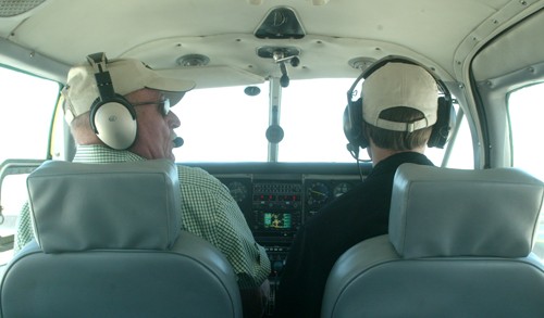 Ralph Rina, a certified flight instructor of 40 years, discusses what hes doing with his student, Daniel Lamb, a media arts sophomore in training for a twin engine license.  
