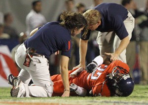 Athletic trainers examine UA defensive back Nate Ness after he flipped in the air when he was blocked by USC running back Stafon Johnson in Arizonas 17-10 loss Saturday night at Arizona Stadium. A handful of Wildcats were injured in the game, but they will be 100 percent healthy heading to Washington State.