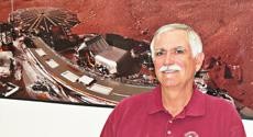 Peter Smith, principal investigator for the Phoenix Mars Lander, stands in front of an image of the lander outside the Lunar and Planetary Sciences Lab Tuesday afternoon. 