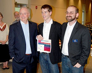 Innovation Day project winners Joshua Scott, center, and Thomas Strong, right, hold their certificate with Harry George, a venture capitalist from the Center for Innovation. More than 19 different groups participated in Innovation Day, all showcasing their own business models for local investors and entrepreneurs.