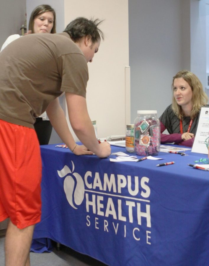 Management junior Karen Johnston helps run a raffle table for students yesterday at the Rec Center.  The event was part of Sex Talk, a program designed to educate the student body on healthy sexual practices.