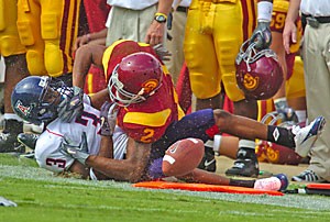UA junior cornerback Wilrey Fontenot and USC senior wide receiver Steve Smith fight it out as the ball drops to the ground in last years game at the Coliseum. Smith and Fontenot are sure to see a lot more of each other tomorrow when USC and Arizona clash at Arizona Stadium.