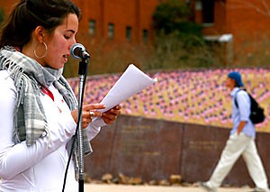 Laura Gelinas, a business freshman and member of the UA Young Democrats, reads the names of soldiers killed in Iraq over a loudspeaker yesterday afternoon on the Alumni Plaza. More than 3,000 American flags representing every American soldiers life lost since 2003 were planted on Heritage Hill.