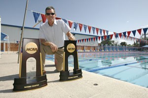 UA head swim coach Frank Busch shows off his two national championship trophies. The mens and womens swim teams won their first national championships in UA history.
