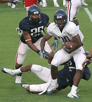 Xavier Smith (30) doesnt know it yet, but hes about to get popped by Adrian McCovy (25), the biggest hitter on the team. McCovy would cause and recover the fumble, before doing what he likes to do best ? celebrate.