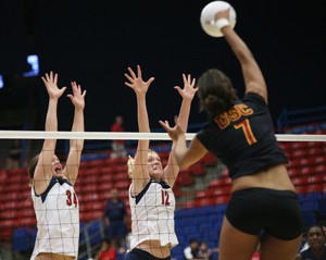 UA middle setter Paige Weber (34) and blocker Jacy Norton (12) attempt to block USCs Alex Jupiter during a 3-2 Arizona win Oct. 19 in McKale Center. The Wildcats host No. 6 California tonight at 7 and No. 2 Stanford at the same time Saturday.